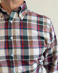 Plaid shirt with a visible brand logo on a neutral background