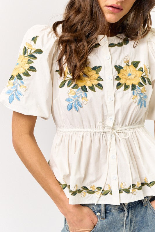 woman wearing an embroidered floral blouse