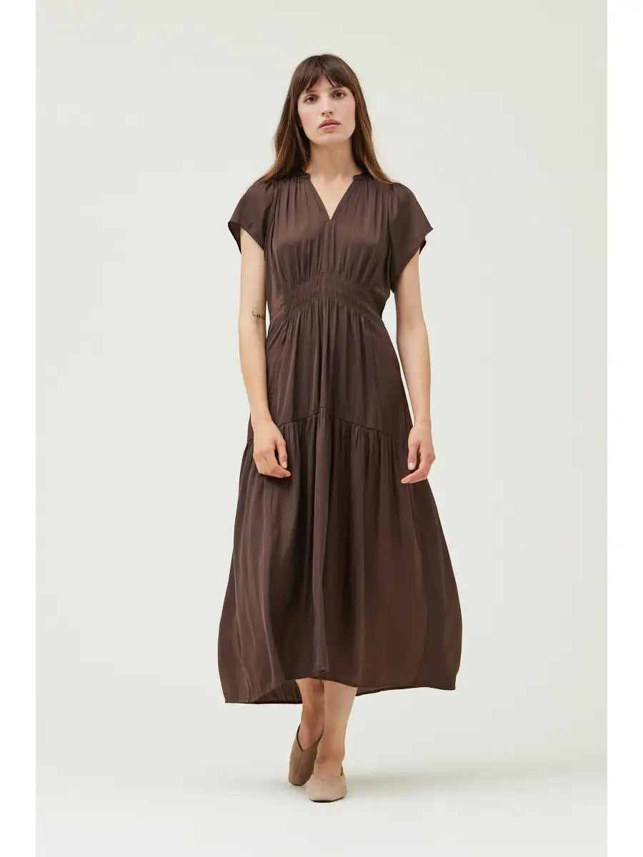 Woman wearing a brown dress on a white background