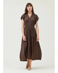 Woman wearing a brown dress on a white background