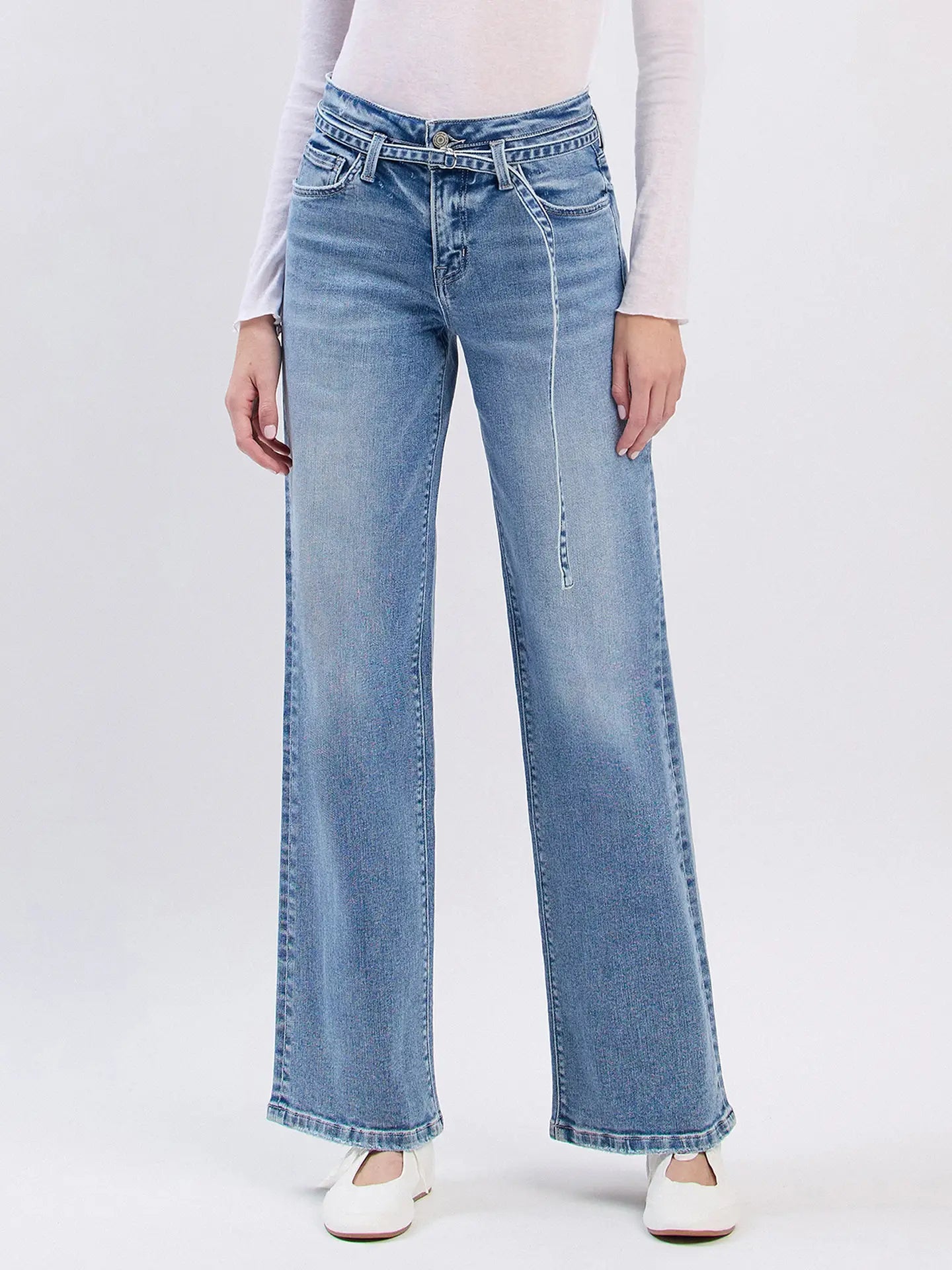 Light blue jeans worn by a person on a white background