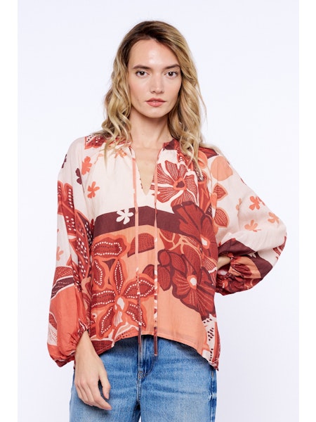 Woman wearing a floral blouse with a white background