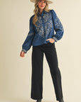 persian blue long sleeve blouse embroidered with white design, a collar, and buttons