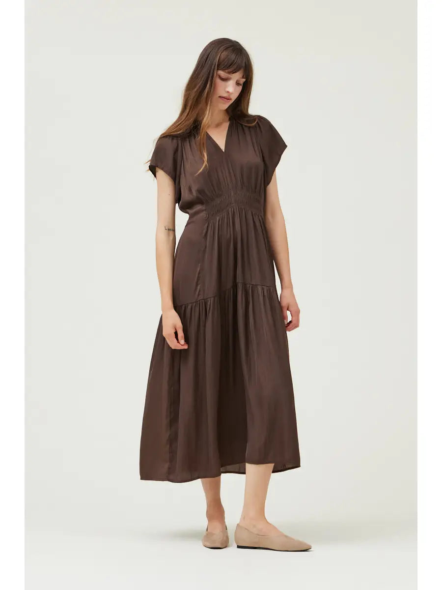Woman wearing a brown dress on a white background