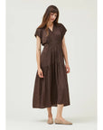 Woman wearing a brown dress on a white background