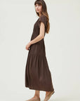 Woman wearing a brown dress on a white background