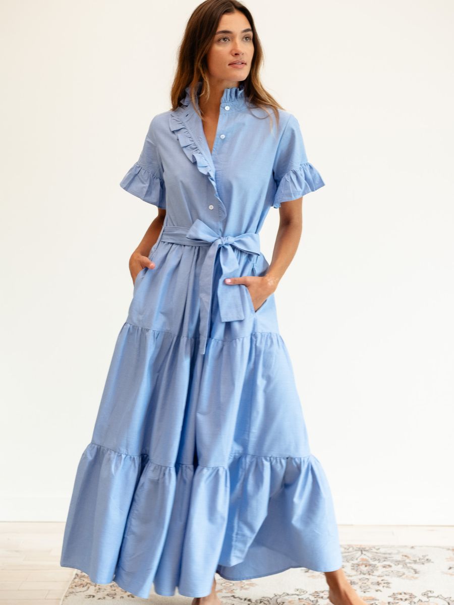 Woman wearing a blue dress with a white background