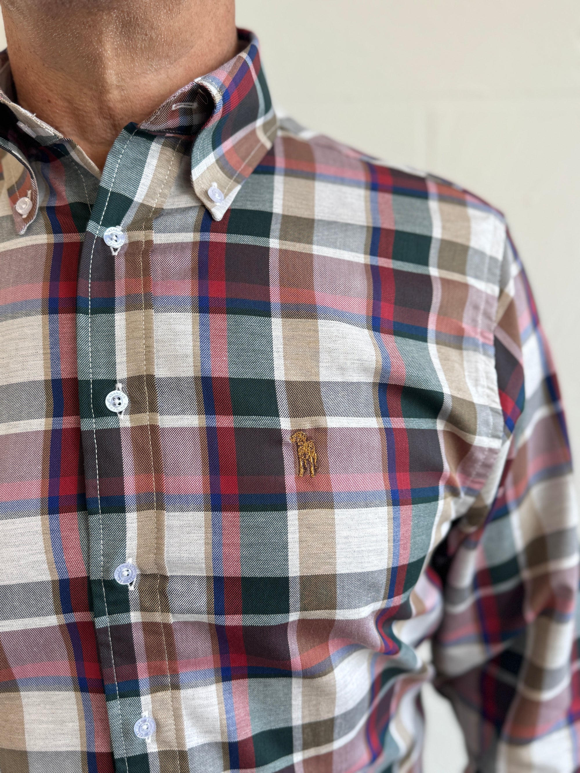 Plaid shirt with a visible brand logo on a neutral background