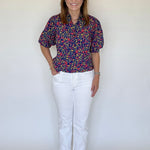 A model posing in the Strahley Top in Ditsy Floral by LaRoque, from Chatsworth Boutique in Fairhope, Alabama.