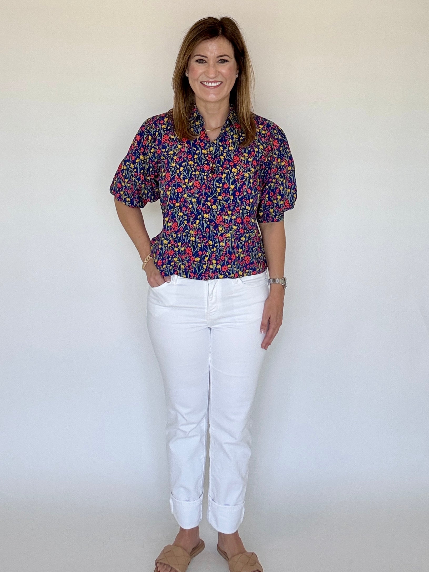 A model posing in the Strahley Top in Ditsy Floral by LaRoque, from Chatsworth Boutique in Fairhope, Alabama.