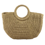 Beige woven handbag on a wooden surface