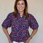 A model wearing the Strahley Top in Ditsy Floral by LaRoque, from Chatsworth Boutique in Fairhope, Alabama.