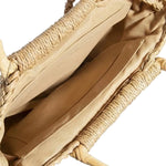 Close-up of a beige woven bag with a light blue background