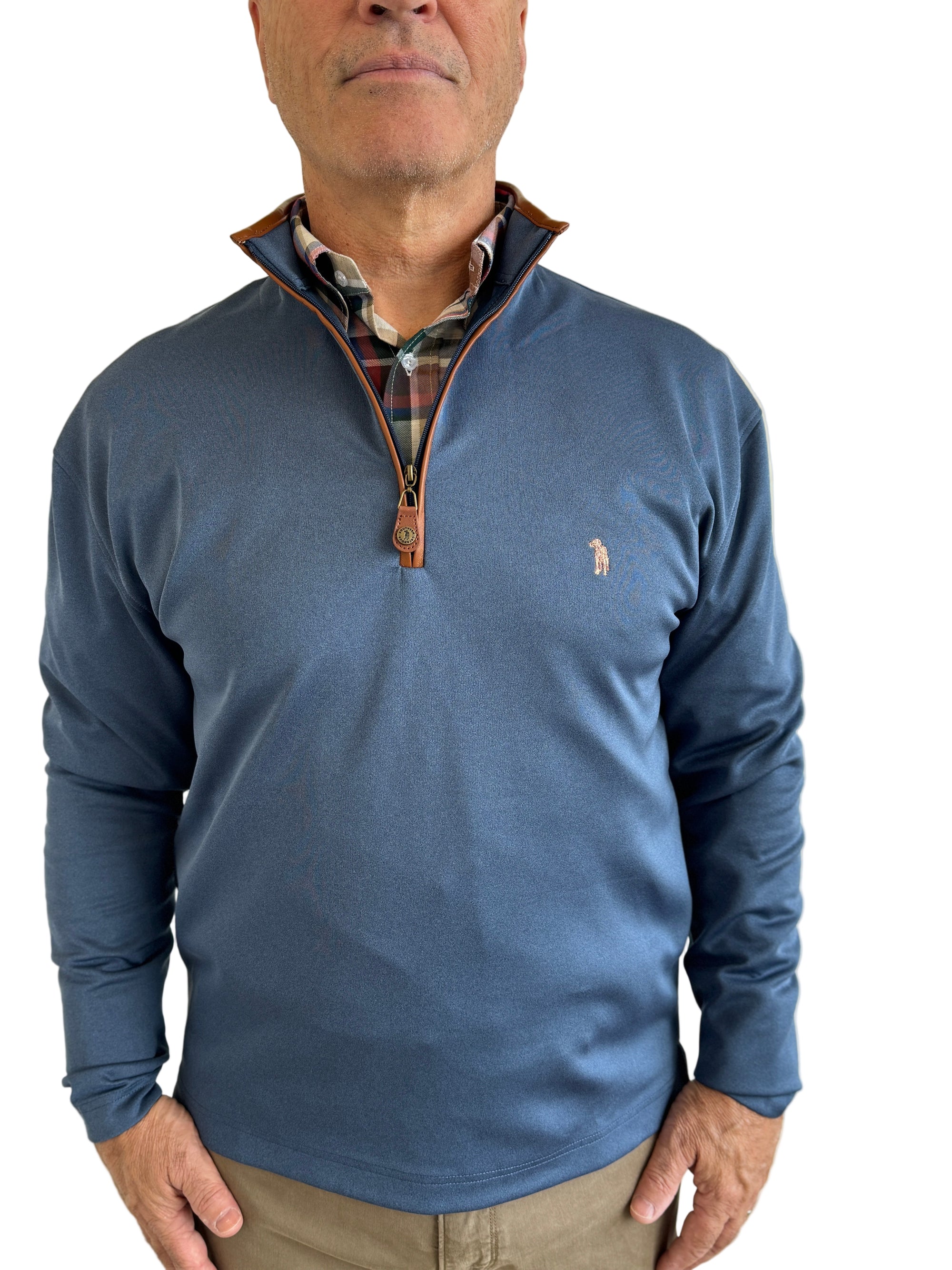 Man wearing a blue pullover with a visible brand logo against a plain background
