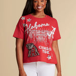 A red boxy fit womens tee for Alabama Crimson Tide with Big Al logo on a silhouette of Bryant-Denny Stadium.