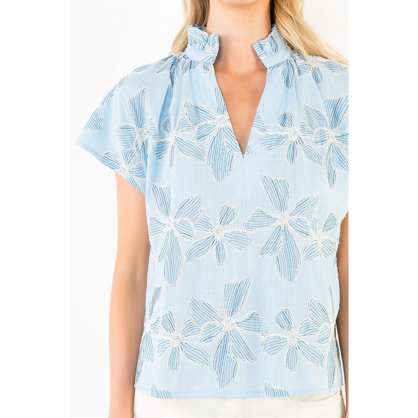 Light blue floral blouse on a white background