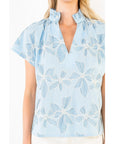 Light blue floral blouse on a white background