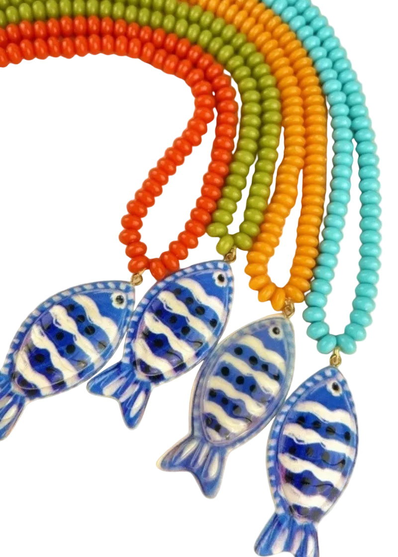 Colorful beaded necklaces with fish-shaped pendants on a beige background