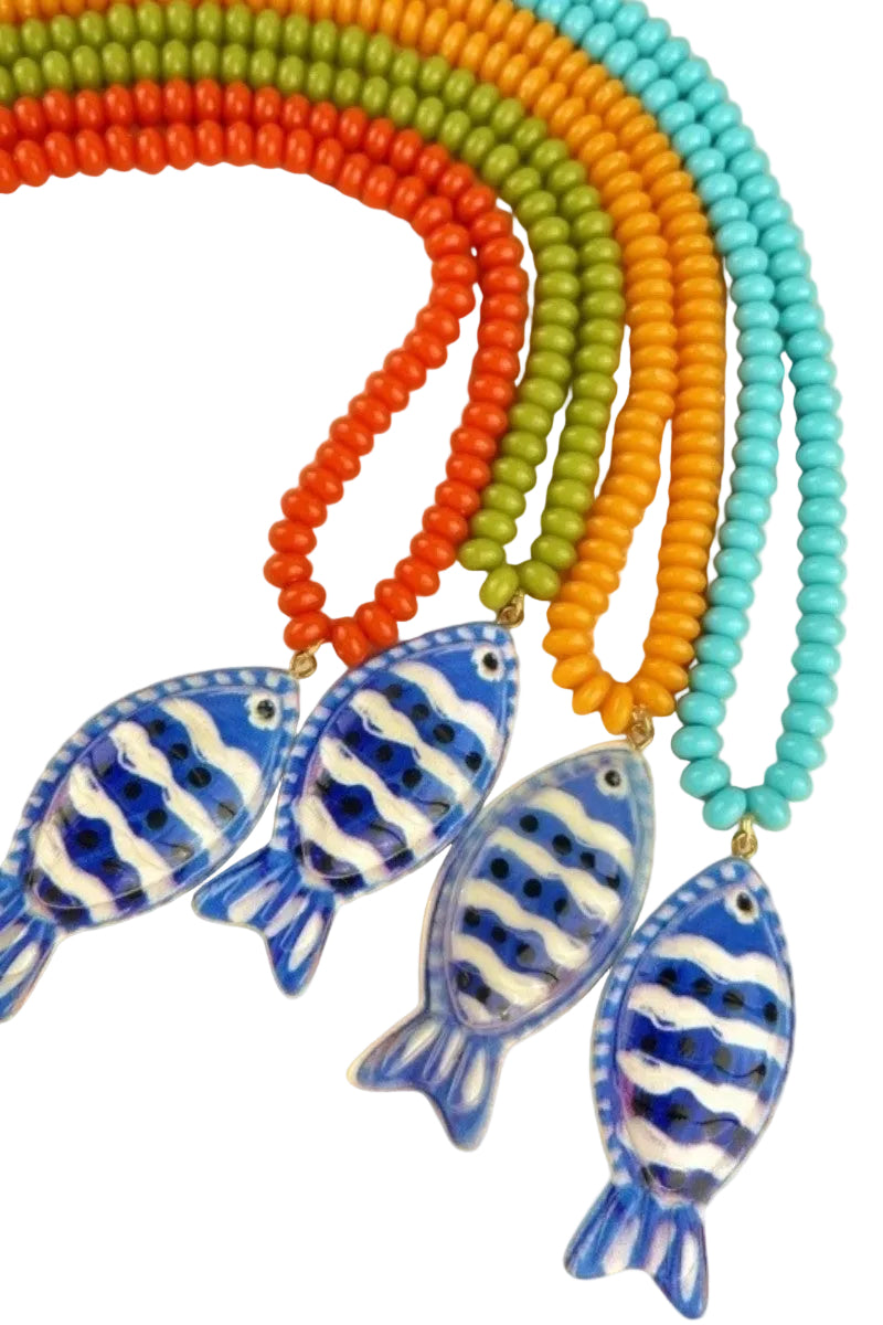 Colorful beaded necklaces with fish-shaped pendants on a beige background