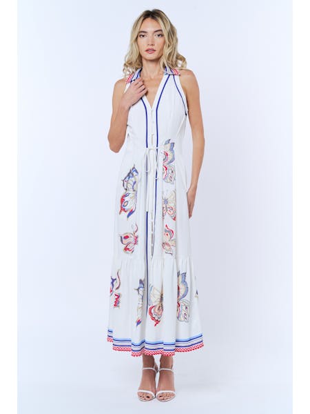 Woman wearing a white dress with colorful patterns on a white background