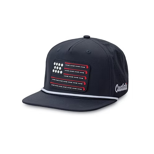 a navy hat with a white rope detail along bill and an american flag in golf clubs and balls.