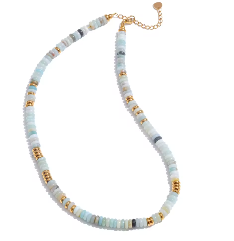 Necklace with light blue, white, and gold beads on a white background