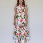 A woman wearing a sleveless maxi shirtdress with a collar and a ruffle at the bottom.