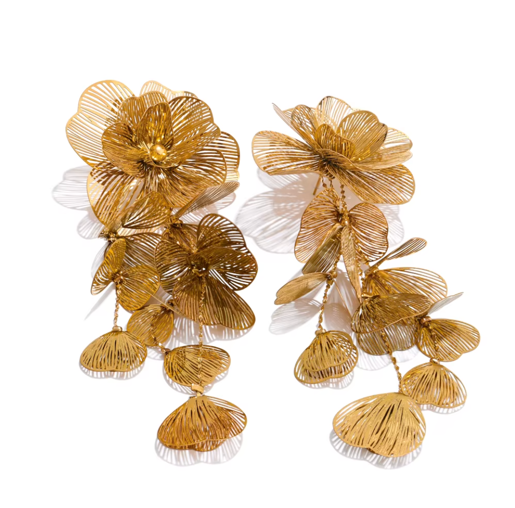Gold floral earrings on a white background