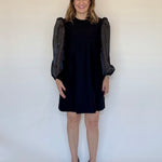 Black Puff Sleeve Mini Dress by Sail to Sable with sheer puff sleeves, styled with black pumps