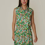 Woman wearing a floral dress against a plain background