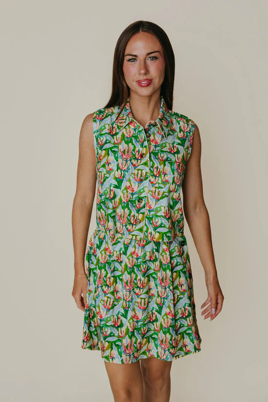 Woman wearing a floral dress against a plain background