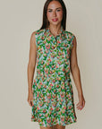 Woman wearing a floral dress against a plain background