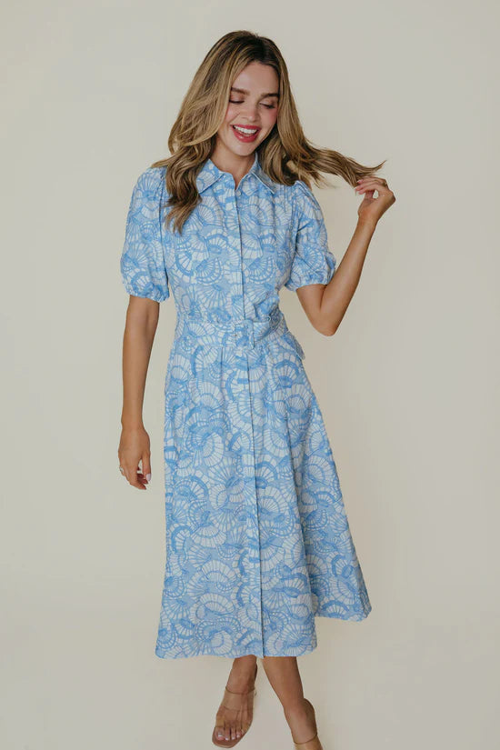 A blue and white collared midi shirtdress with a belt.