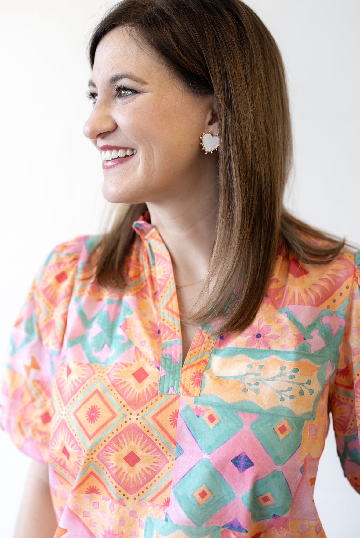 photo of chatsworth owner, Leah, looking off to the side wearing a bright orange and pink top