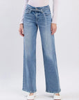 Light blue jeans worn by a person on a white background