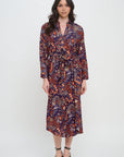 Woman wearing a patterned dress on a white background