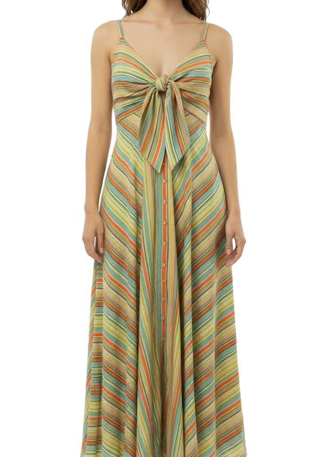 A woman wearing a lime green orange and blue stripe spaghetti strap dress with a bow at the bust.