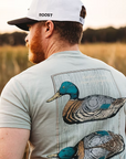 Man wearing a t-shirt with a mallard duck design outdoors