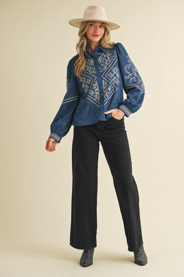 persian blue long sleeve blouse embroidered with white design, a collar, and buttons 