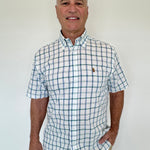 Man wearing a checkered shirt with a logo on a white background