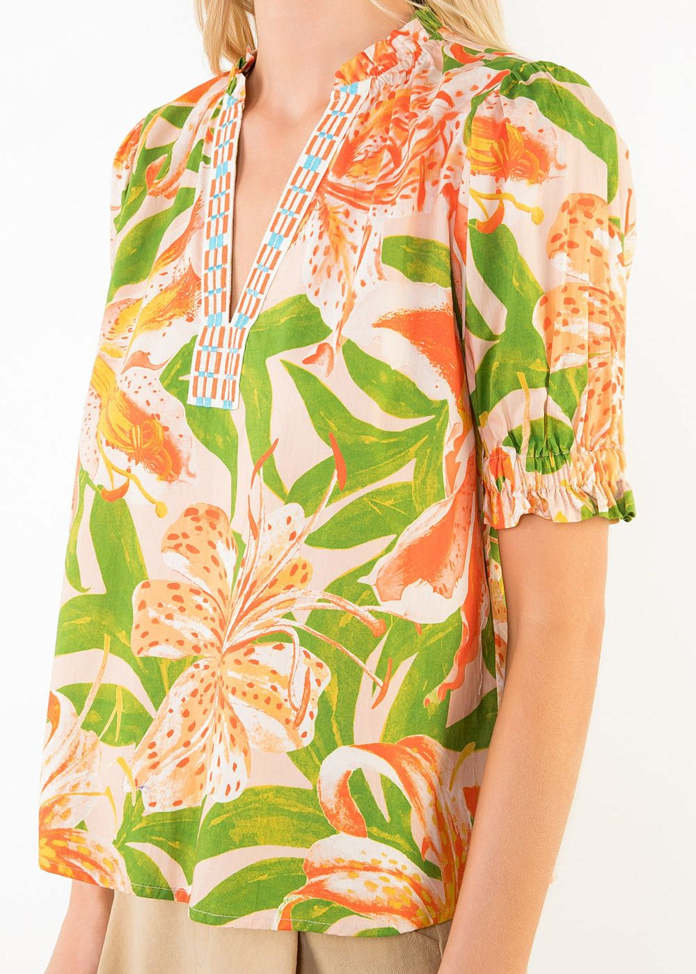 Tropical floral patterned top worn by a person