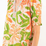 Tropical floral patterned top worn by a person