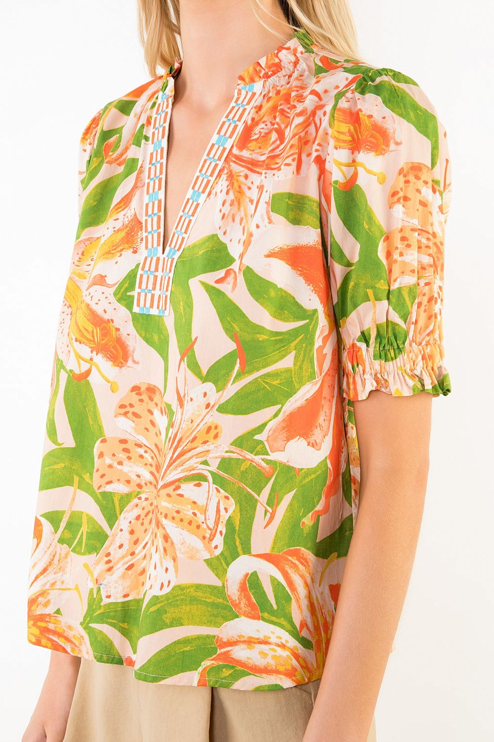 Tropical floral patterned top worn by a person
