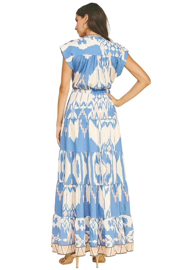 Woman wearing a blue and white patterned dress on a beige background