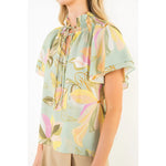 Woman wearing a floral blouse with a white background