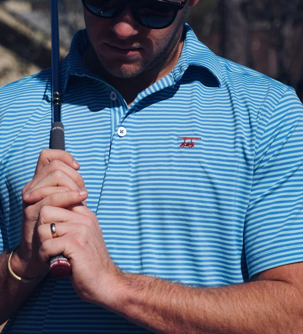 A man wearing the Albatross Performance Golf Polo in Aruba/Regatta Stripe by Bald Head Blues, front view, from Chatsworth Boutique in Fairhope, Alabama.
