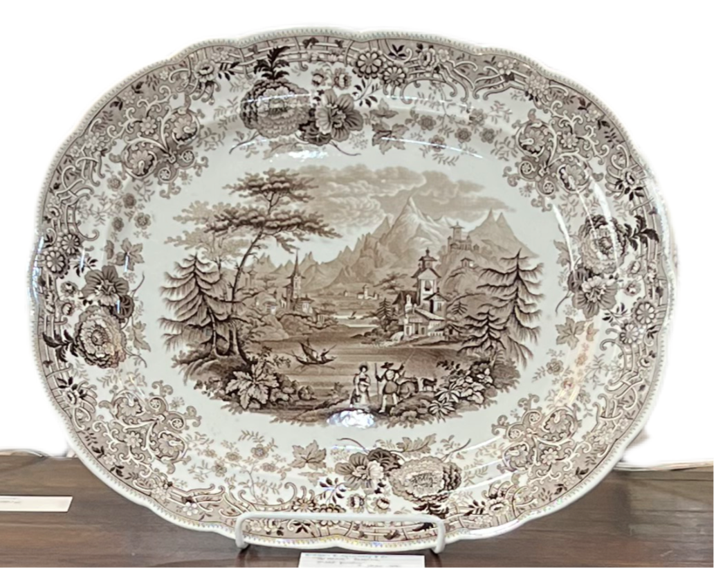 antique brown transferware platter on platter stand