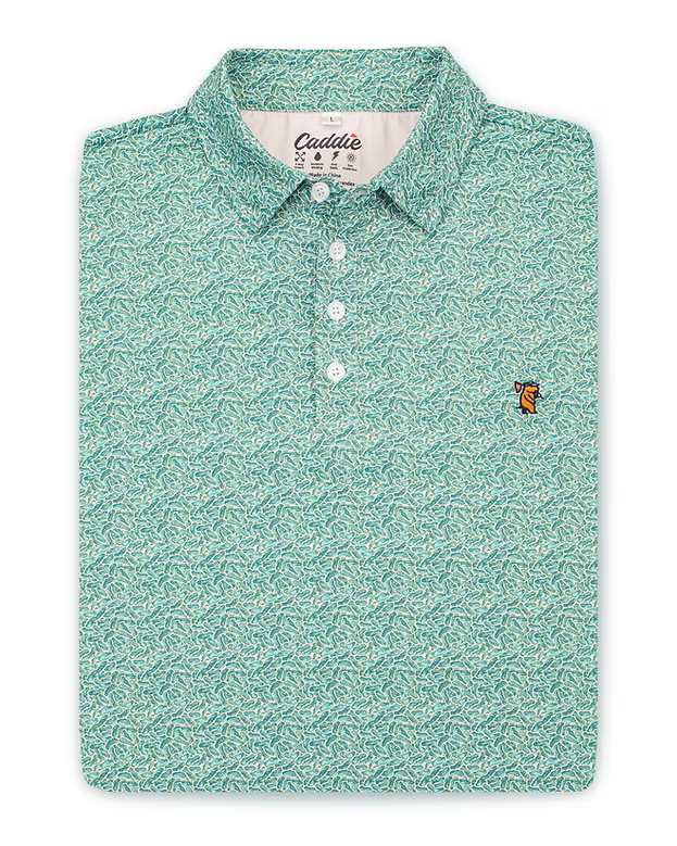 Flat lay front view of the Caddie Greens Polo, featuring a photographic golf course green micro print, from Chatsworth Boutique in Fairhope, Alabama.