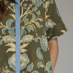 Another front view of the Contrast Trim Shirtdress Midi by Entro, highlighting the lightweight olive floral fabric and midi length, from Chatsworth Boutique.