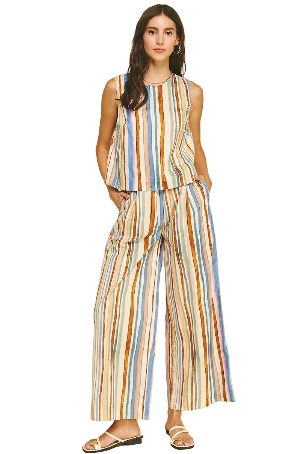 Woman wearing a multicolored striped outfit on a beige background